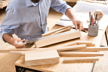Lumber craftsman working with materials at workplace
