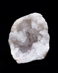 Clear crystal quartz geode with crystalline druzy center on black background