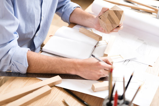 Lumber Craftsman Making Drafts Of Future Manufacture At Workplace