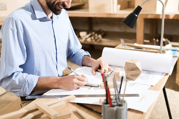 Carpenter is laboring in his workshop