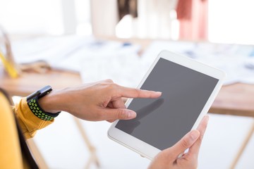 Fashion designer using digital tablet in office