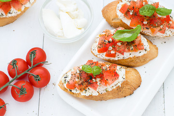 Bruschetta with cream cheese, tomatoes and basil