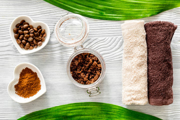 Organic coffee soap, coffee grains and towel on wooden background top view