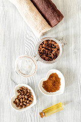 Organic coffee soap, coffee grains and towel on wooden background top view