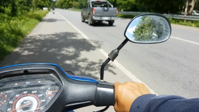 4K POV asian man riding motor bike cycle on the street focus on the right hand