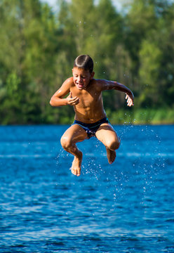 Young Boy Jumping Into Water