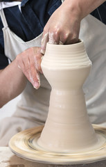 Hands of a potter in the period of work on the production of clay products 