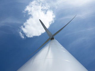 wind turbine and blue sky with one cloud
