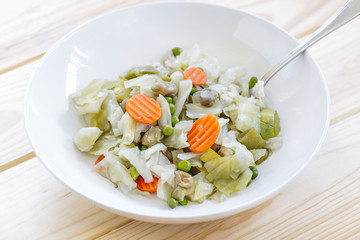 Dish with Mix of cooked vegetables on wooden table. Diet and healthy food concept. Vegetarian food