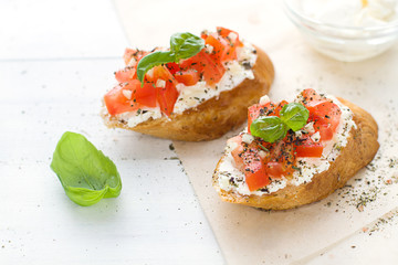 Bruschetta with cream cheese, tomatoes and basil