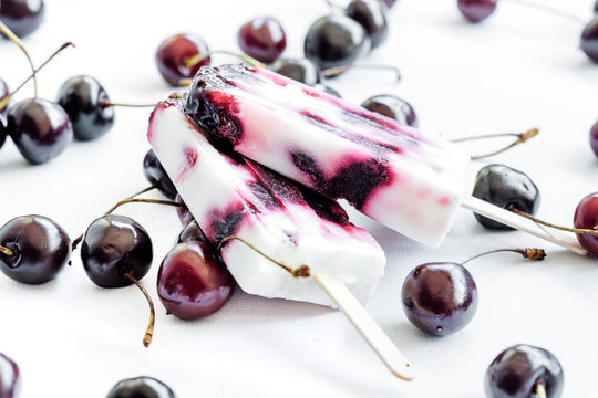 Healthy summer dessert. Yogurt and cherries popsicles.