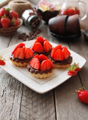 Cheese tartlets with chocolate and sweet strawberry dessert 