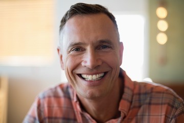 Man smiling at camera in restaurant