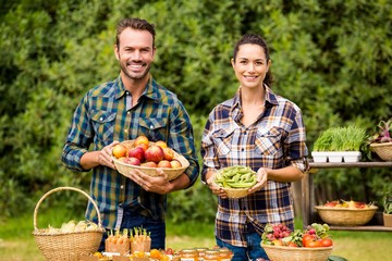 Portrait of couple selling organic vegetables