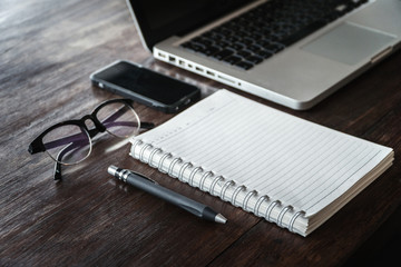 blank notebook mock up,workspace on table,working on desk concept,business office equipment,portable device and gadget accessories,selective focus and vintage tone