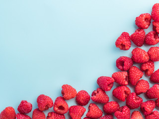 Raspberry on blue background with copy space