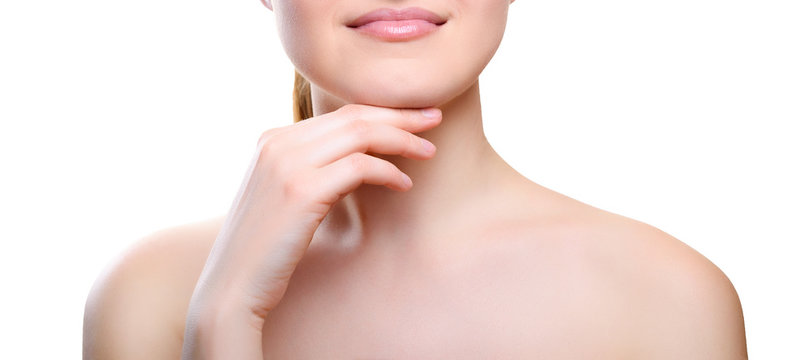 Portrait of girl with nude make-up with hands on chin isolated on white background. Girl with clean healthy skin on white. Cosmetology, medicine, beauty care. Nude makeup