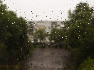 rain drops on glass, street views, green trees,