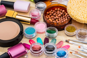 Obraz na płótnie Canvas different makeup products - lipstick, eye shadows, nail polish, powder