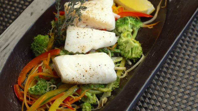 fish steamed with vegetables on the table