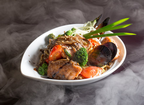 noodles with vegetables, meat and mussels