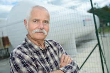 senior worker on the industrial building background