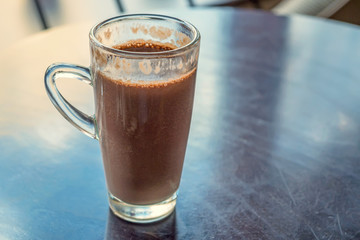 Close up glass with cocoa on table