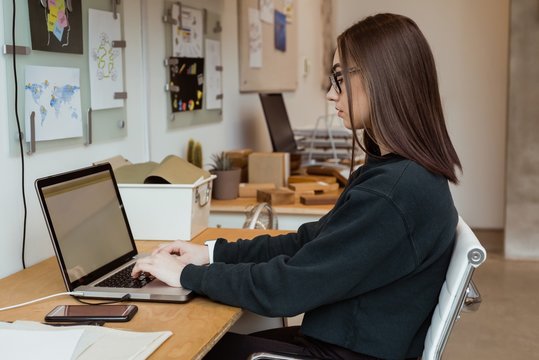 Female executive working on laptop at desk
