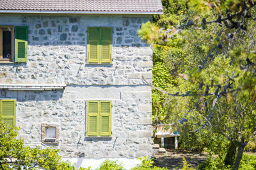 View of one old building against a majestic mountain landscape and italian vineyards in Cinque Terre