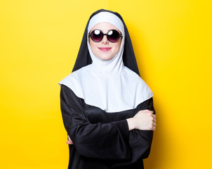Young happy nun with sunglasses