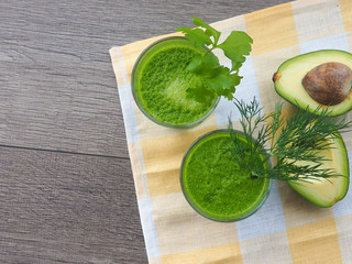 Healthy green vegetable juice on wooden table