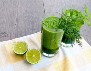 Healthy green vegetable juice on wooden table