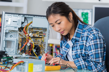 Asian woman repairing computer