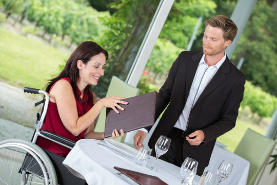 wheelchair user dinning at a restaurant