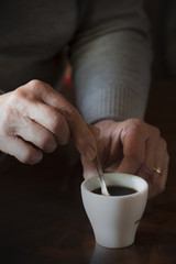 Mixing sugar in the coffee cup