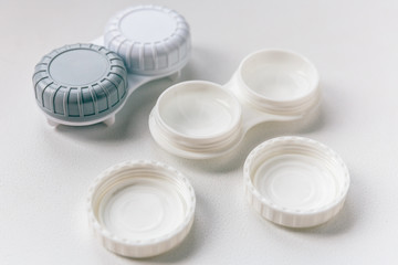 Closed and open containers for contact lenses