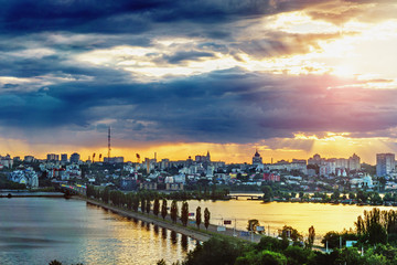 Fototapeta premium Colourful sunset cityscape. Panoramic aerial view of Chernavsky Bridge from roof top at sunset, Voronezh