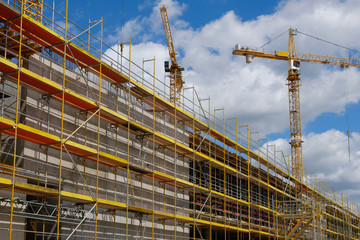 new building construction site,  scaffolding and crane on building site