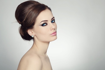 Young beautiful woman with stylish make-up and hair bun