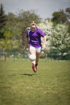 Full length of woman playing soccer