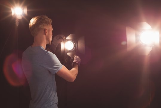 Photographer adjusting strobe light