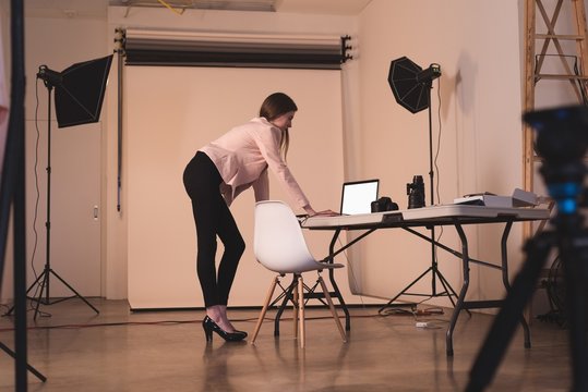 Full length of model using laptop