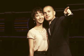 Happy young fashion couple in love in night city street