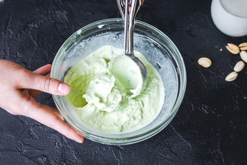 organic ice cream homemade process on dark background with hands