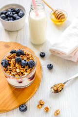 Fitness breakfast with granola, milk and honey on white backgrou