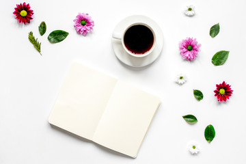 Froral flat lay with cup and notepaper top view mockup