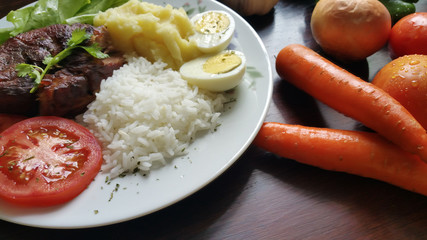 Closeup dish with lunch and fresh vegetables on the wooden table