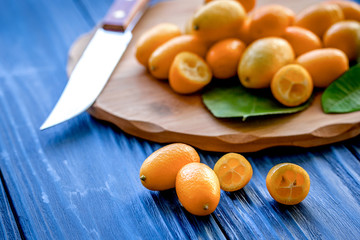 kumquat on plate at wooden table