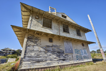 close-up of vacant decayed house with blown out windows