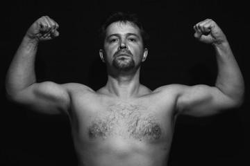 Fototapeta na wymiar Muscular man showing his muscles